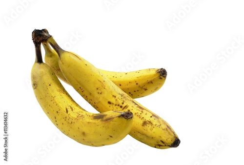 Three juicy ripe banana yellow with brown spots and dots to burst the skins - signs of maturity. Isolated on white background, closeup