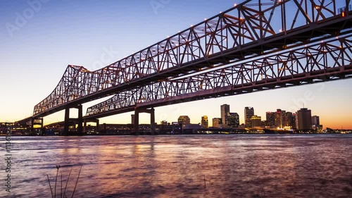 Crescent City Connection Bridge carries traffic over the Mississippi River into New Orleans at night, skyline timelapse photo