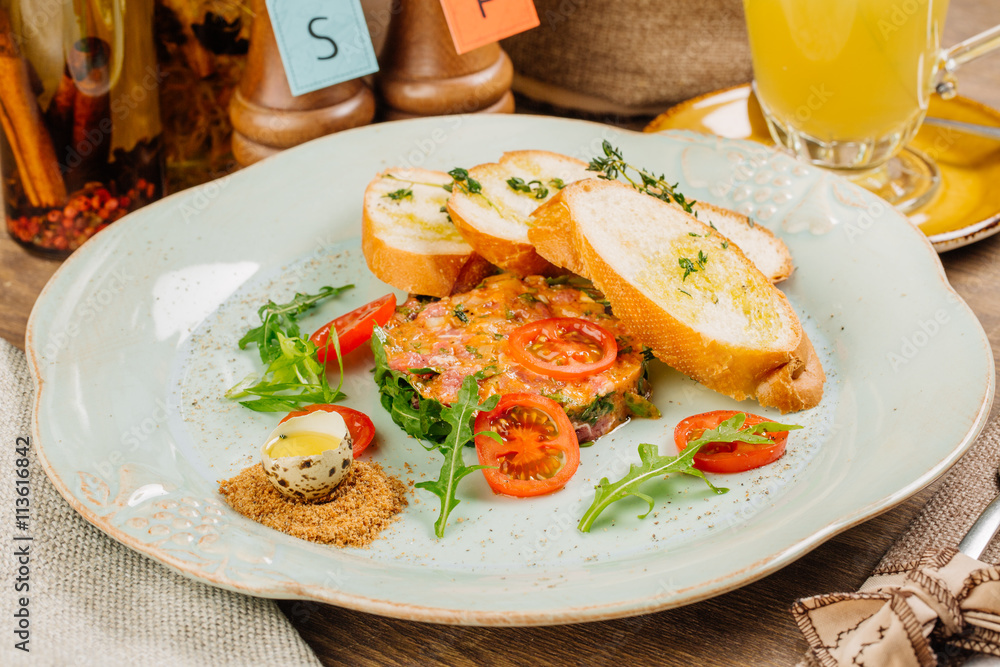 Steak tartare (Raw beef) - classic steak tartare on plate Steak tartare (Raw beef) - classic steak tartare on plate