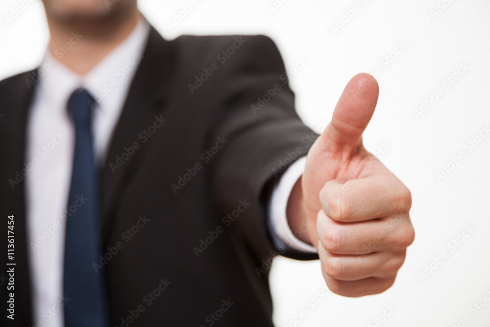 Male hand showing a thumb up sign Male hand showing a thumb up sign