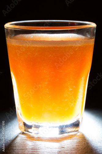 glass of juice on a dark background