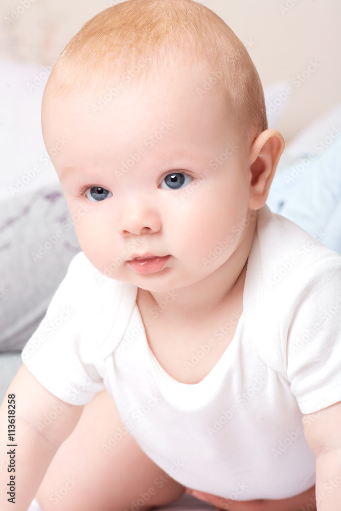 Child,baby happiness concept. Cute baby boy sits quietly on the bed. Child,baby happiness concept. Cute baby boy sits quietly on the bed.