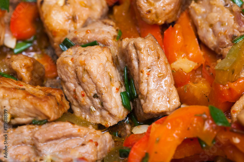 Homemade fried pork with sweet peppers closeup
