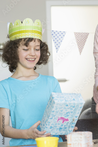 Happy girl holding birthday present photo