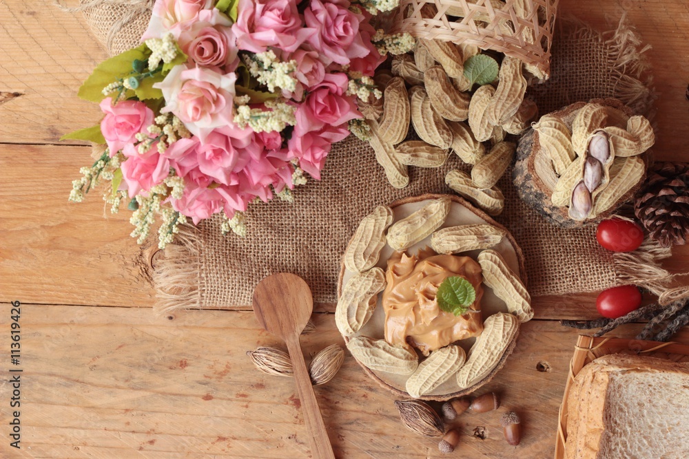 Fototapeta premium Peanut butter and peanut on wood background.