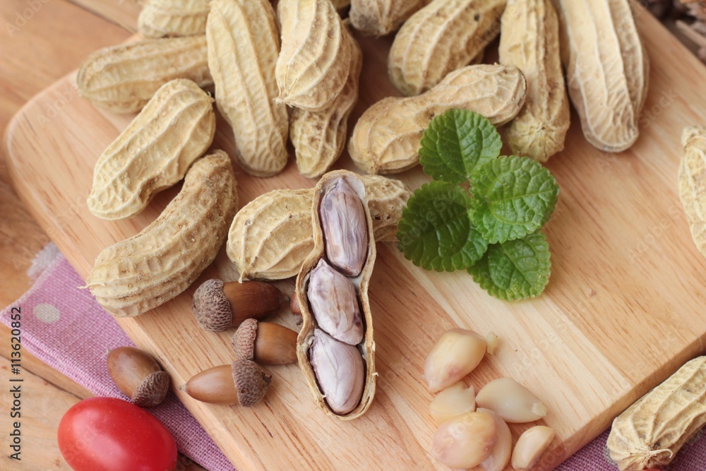 Peanut and boiled peanuts on wood background. Peanut and boiled peanuts on wood background.