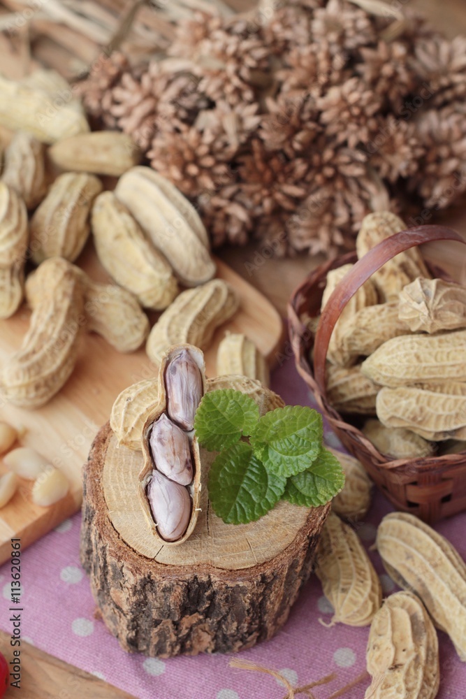 Peanut and boiled peanuts on wood background.