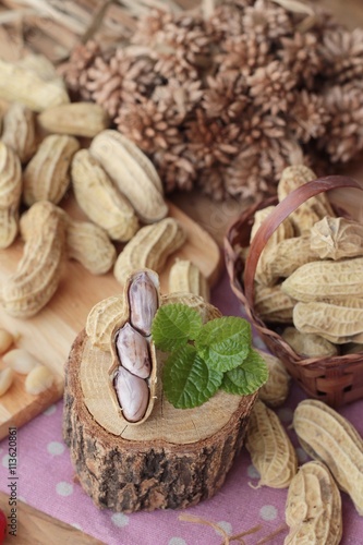 Peanut and boiled peanuts on wood background.