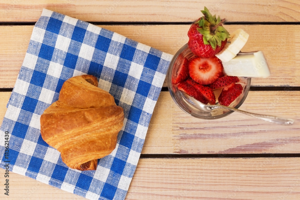 strawberry dessert and croissant cloth on a wooden background strawberry dessert and croissant cloth on a wooden background