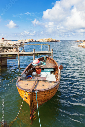 Old fishing boat at a rocky coastline