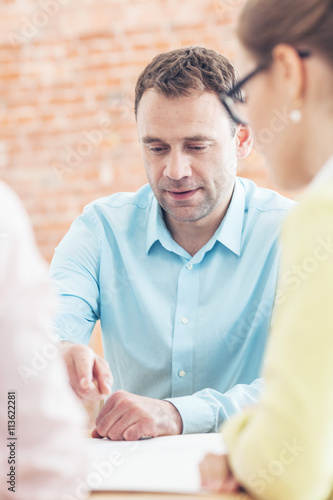 Business team talking at meeting table