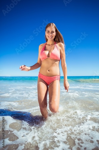 Woman running in water on beach
