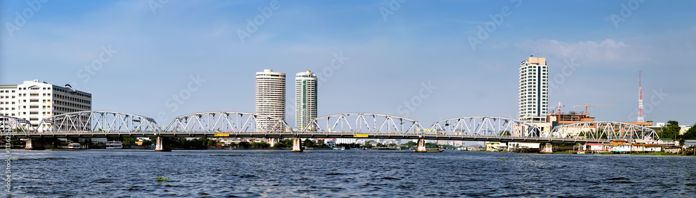 Panoramic view of modern Bangkok with skyscrapers and bridge, Chao Phraya River, Thailand.