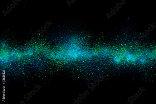 Cyan abstract powder explosion on a black background