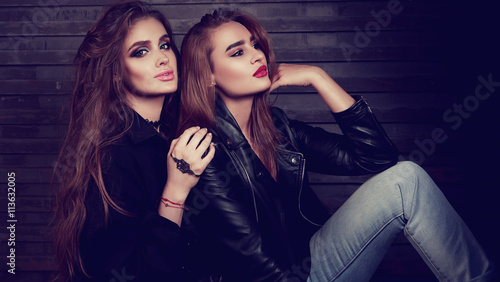 Glamour makeup two women with long hair style sitting on street