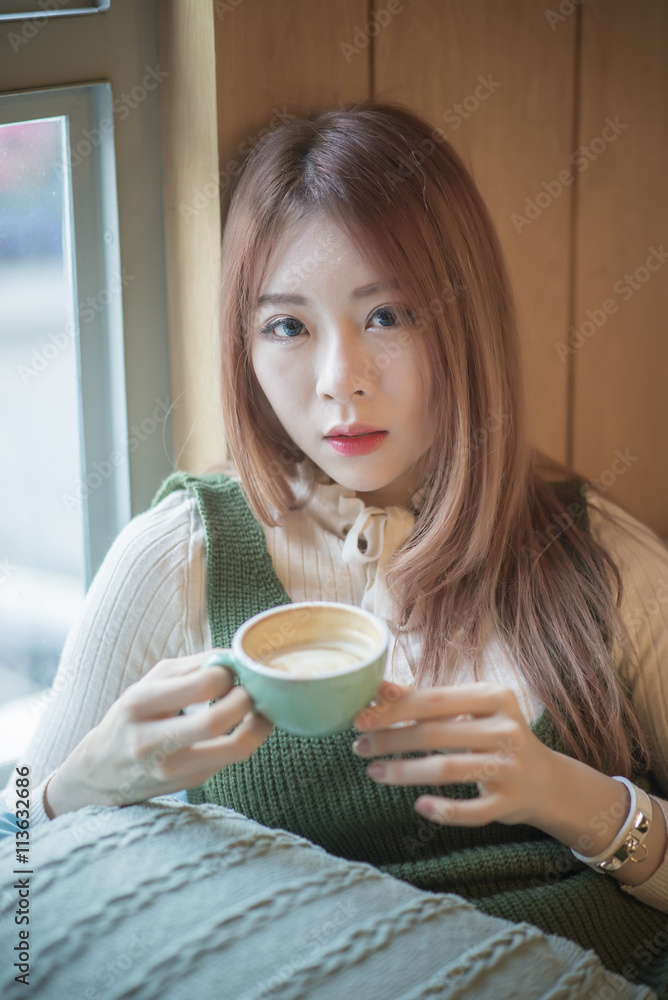 portrait of attractive asian girl in coffee shop portrait of attractive asian girl in coffee shop