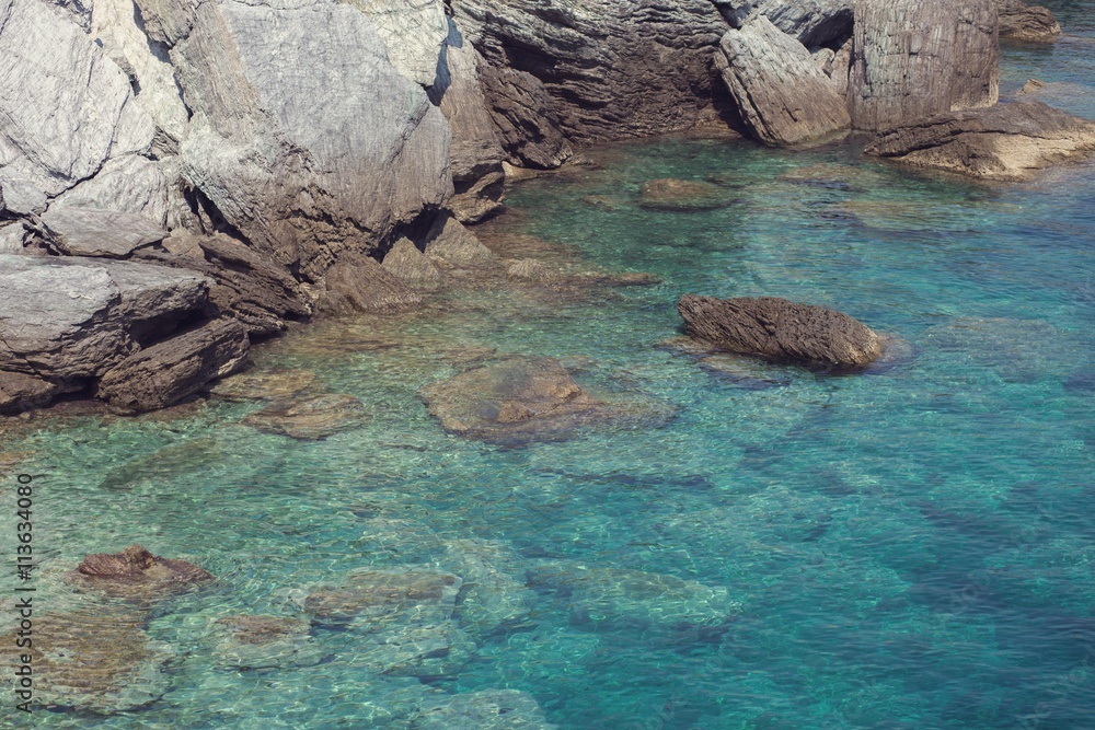 Rocky coastline with turquoise clear water in greek island