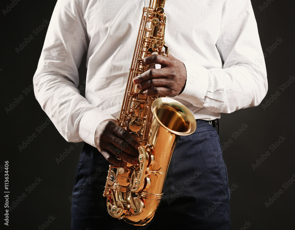 Fototapeta premium African American jazz musician playing the saxophone, closeup