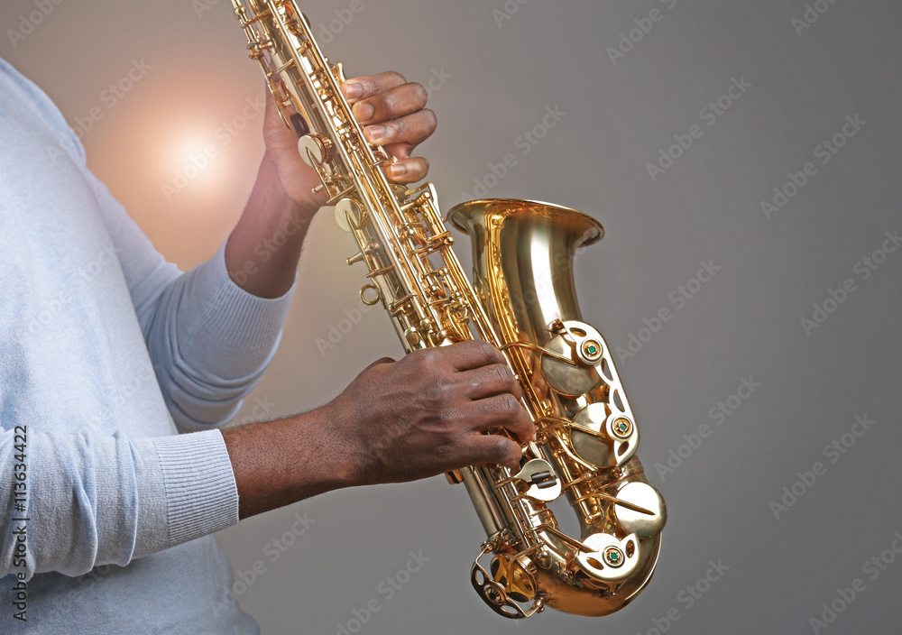 Fototapeta premium African American jazz musician playing the saxophone, closeup