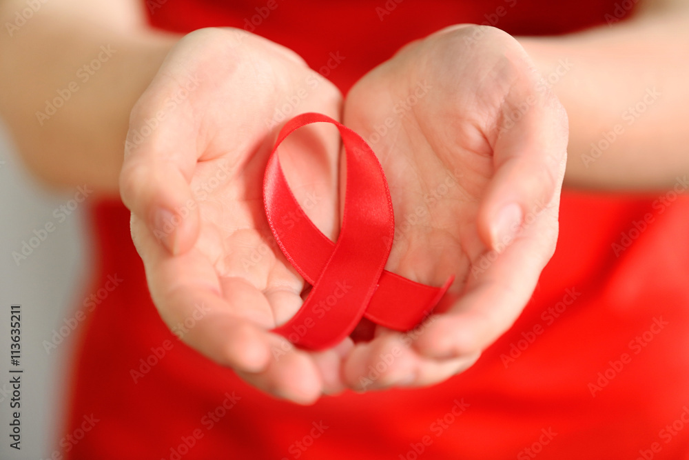 Woman holding red ribbon. Cancer concept Woman holding red ribbon. Cancer concept