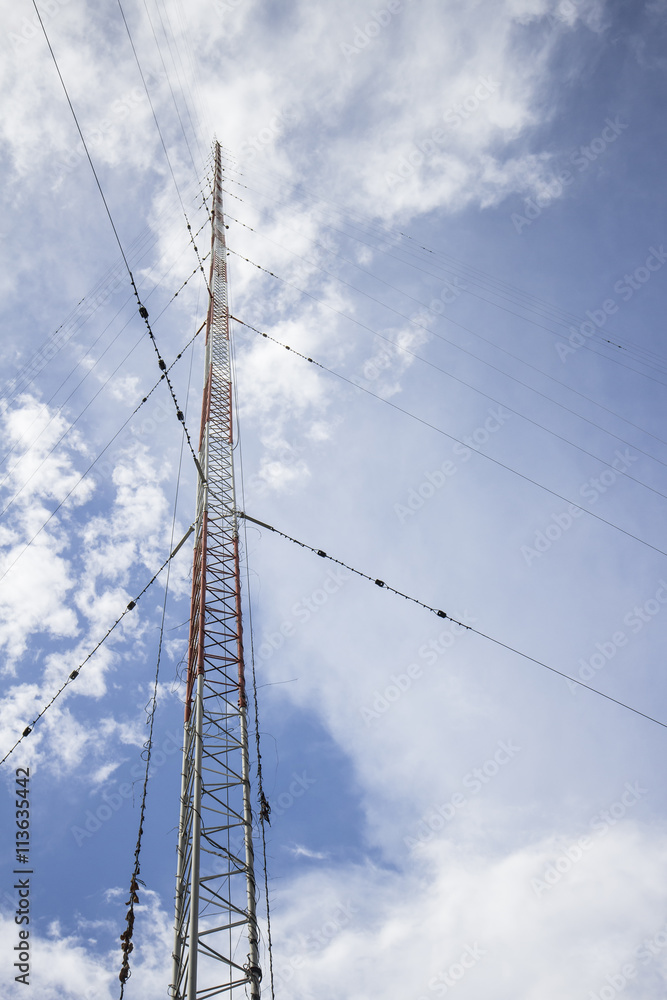 The communication antenna tower on blue sky The communication antenna tower on blue sky