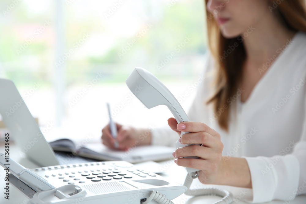 Businesswoman with office IP telephone Businesswoman with office IP telephone