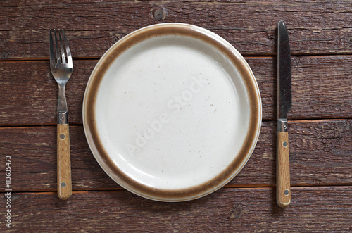 Empty plate, fork and knife