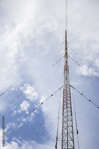 The communication antenna tower on blue sky