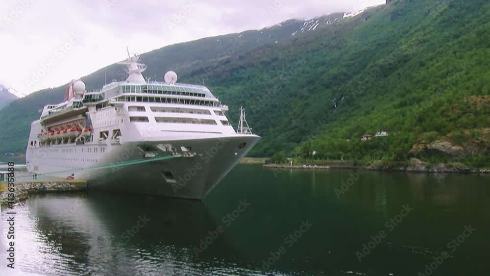 View of big white passenger ship on river at mountains covered by green woods. Summer day. Nature. Landscape View of big white passenger ship on river at mountains covered by green woods. Summer day. Nature. Landscape