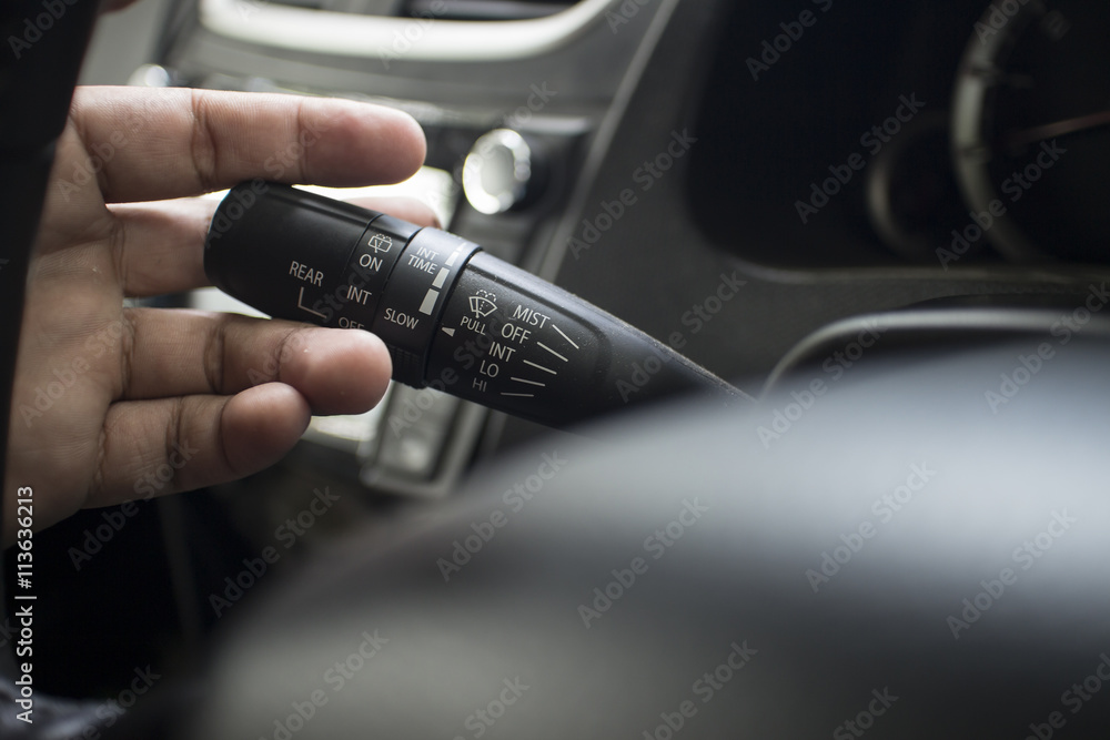 The Finger Push a wiper control button on the car steering wheel