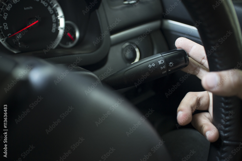 The Finger Push a lighting control button on the car steering wh