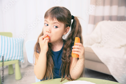 Little girl with carrot in ...