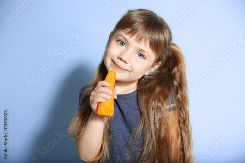 Little girl with carrot on ...
