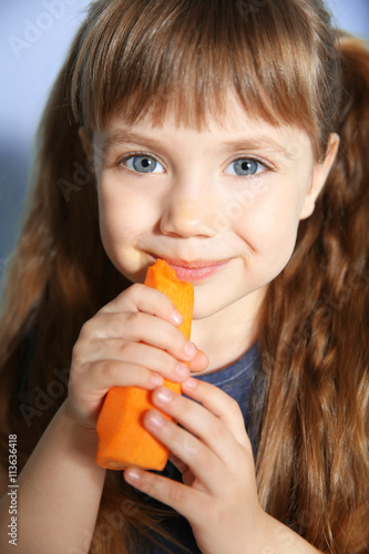 Little girl with carrot, cl...