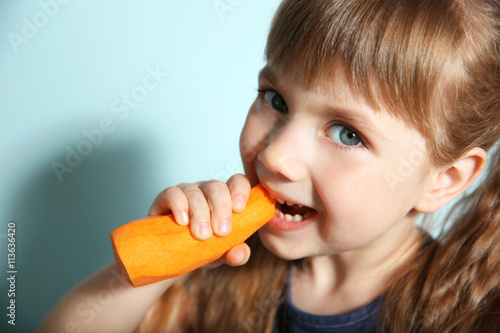 Little girl with carrot, cl...