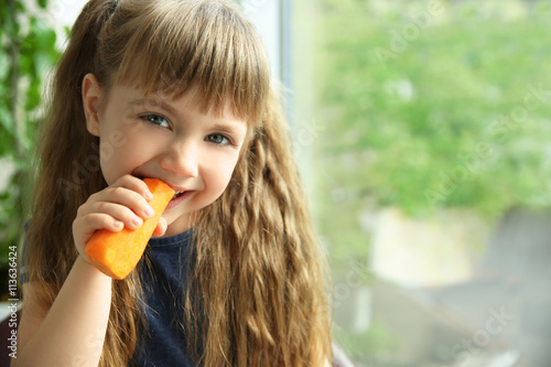 Little girl with carrot on ...