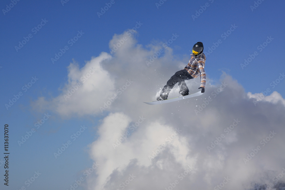 Snowboarder making high jump in cloudy sky.