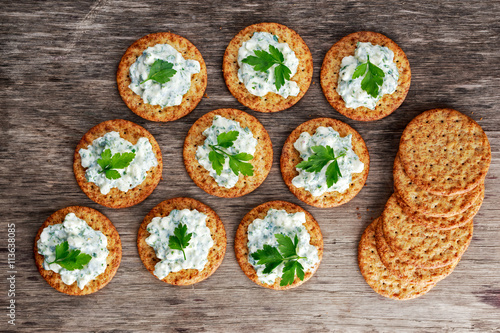 Vászonkép Bisquit cracker appetizers with cottage chees and parsley topping