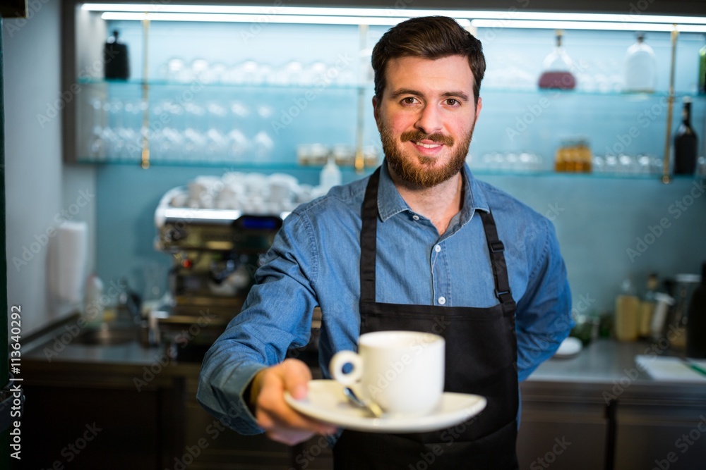 Waiter holding cup of coffee Waiter holding cup of coffee
