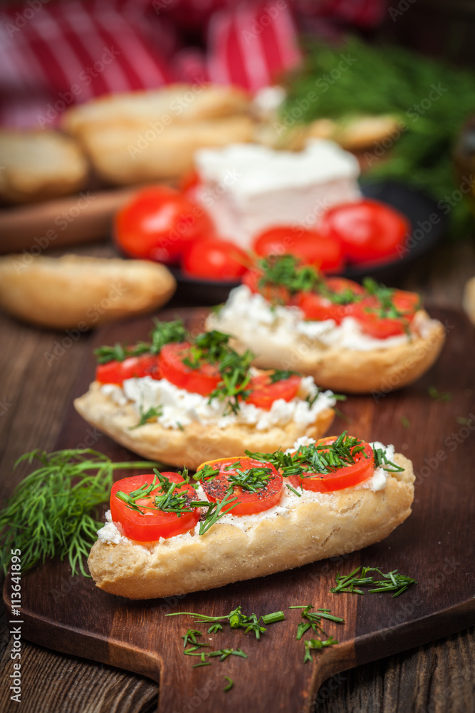 Delicious bruschetta with tomatoes, feta cheese, dill and spice Delicious bruschetta with tomatoes, feta cheese, dill and spice