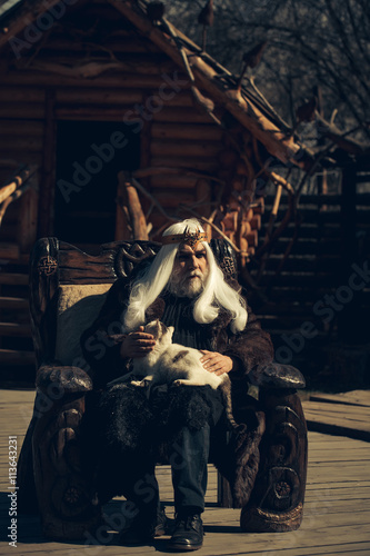 Fototapeta Naklejka Na Ścianę i Meble -  Old druid sits in chair
