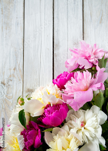 peonies on wooden surface