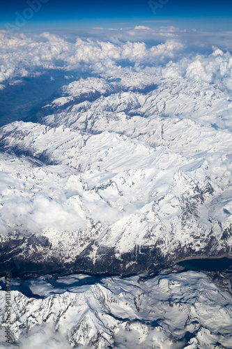 Alps with snow view through the white clouds © IRStone