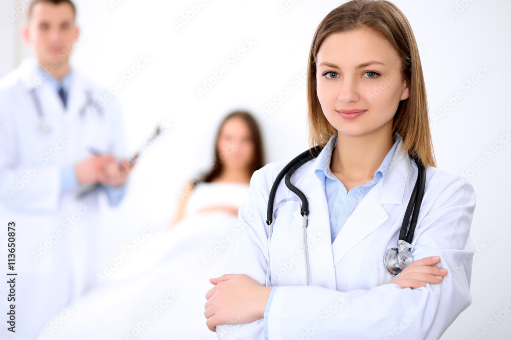 Friendly female doctor on the background with patient in the bed and his doctor Friendly female doctor on the background with patient in the bed and his doctor