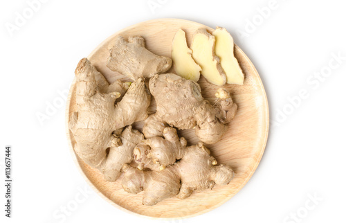 Ginger on wooden plate and white background