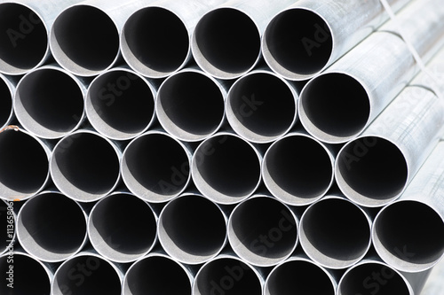 stacking steel pipe at construction site