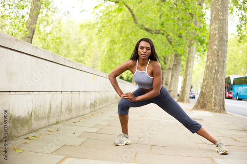 young woman in the street stretching