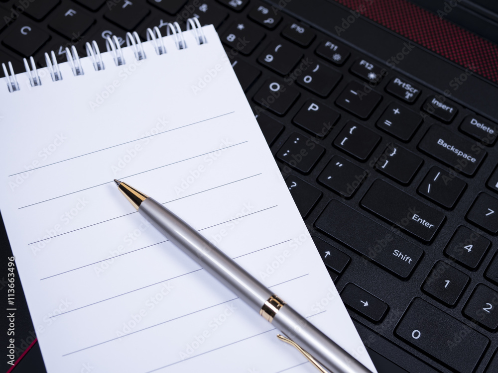 Blank notebook on laptop keyboard 6 Blank notebook on laptop keyboard 6