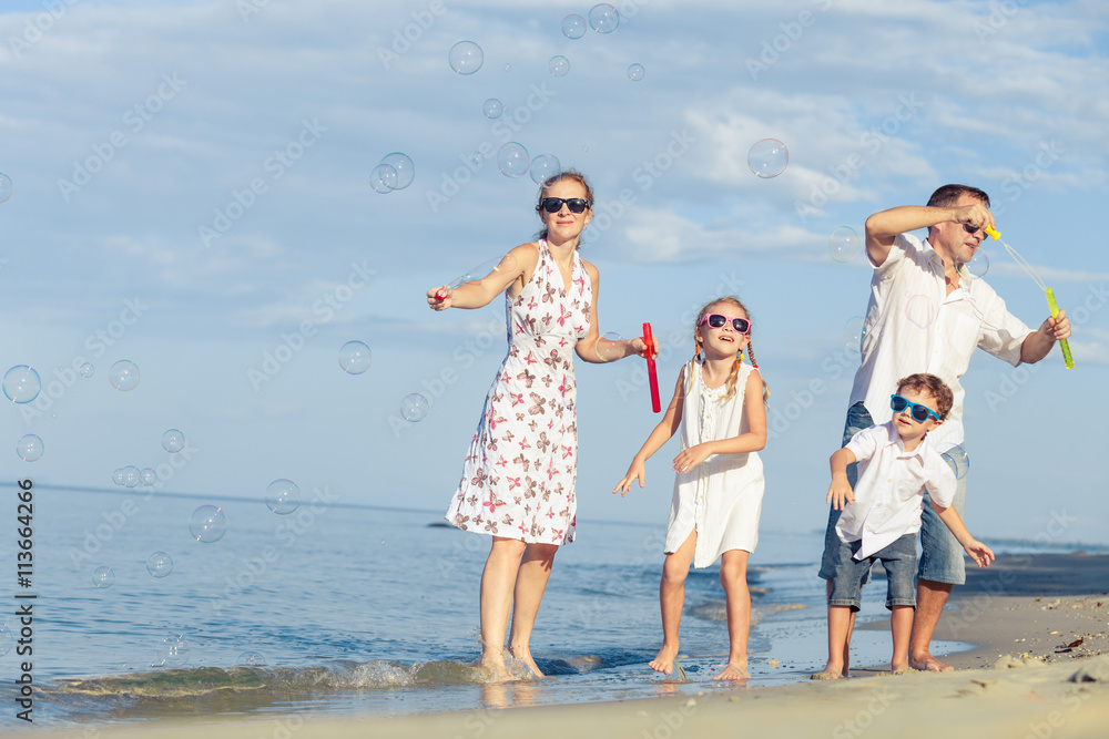 Happy family walking on the beach at the day time. Happy family walking on the beach at the day time.