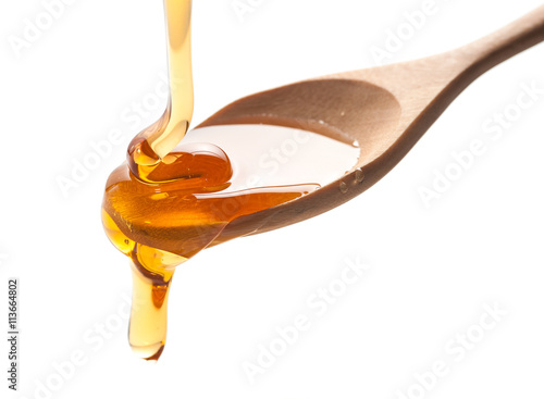 Obraz na plátne syrup pouring on spoon on white background